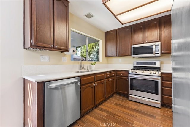 kitchen featuring dark brown cabinets, sink, and stainless steel appliances