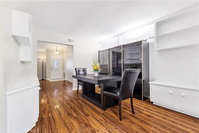 dining space featuring dark wood-type flooring