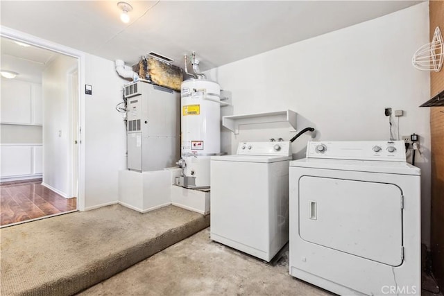 laundry area with heating unit, independent washer and dryer, and water heater