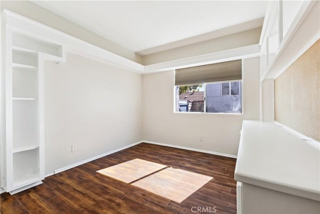 spare room featuring dark wood-type flooring