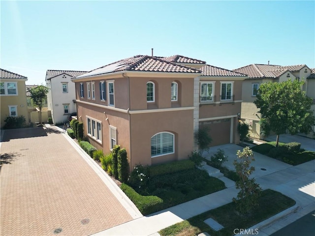 mediterranean / spanish-style home with a garage