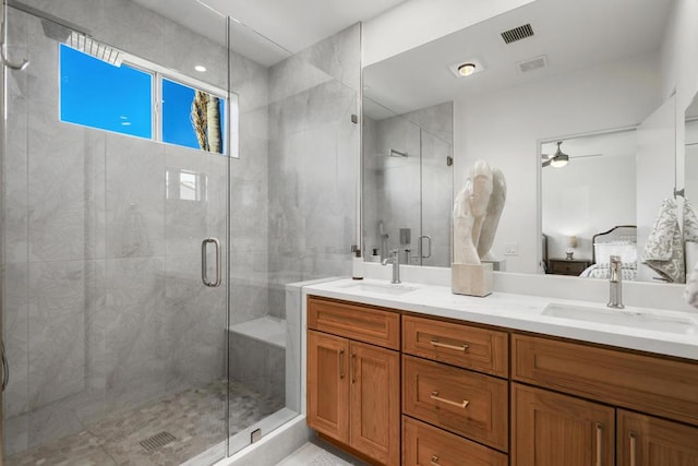 bathroom featuring ceiling fan, vanity, and a shower with shower door