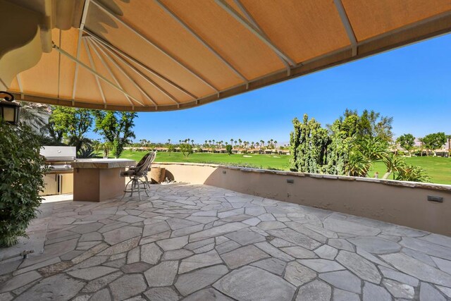 view of patio / terrace featuring area for grilling and an outdoor bar