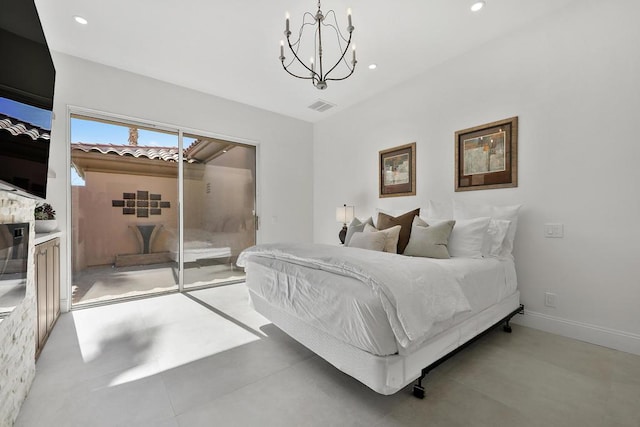 bedroom with access to exterior, concrete floors, and a chandelier