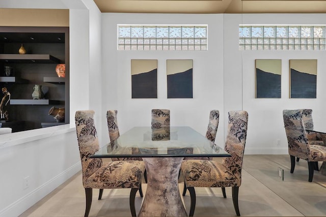 dining space featuring concrete floors