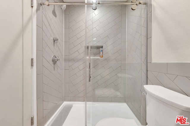 bathroom with an enclosed shower and toilet