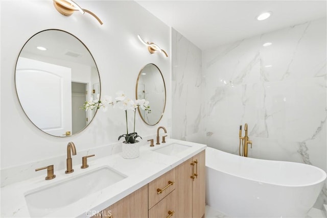 bathroom featuring vanity and a tub to relax in