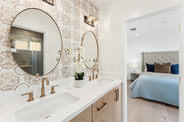 bathroom with hardwood / wood-style flooring and vanity