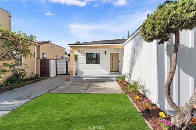 doorway to property featuring a lawn