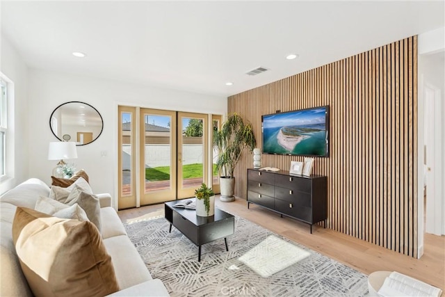 living room featuring french doors and light hardwood / wood-style floors