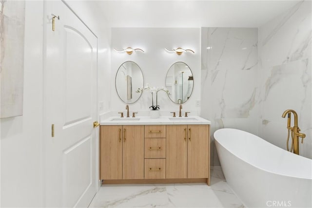 bathroom with a bathtub, tile walls, and vanity