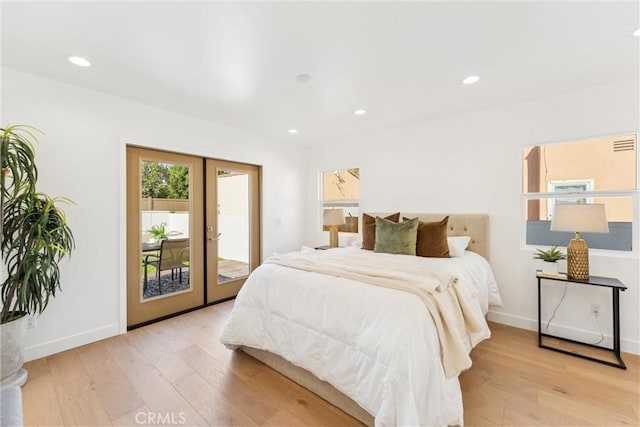 bedroom featuring french doors, access to outside, and light hardwood / wood-style floors