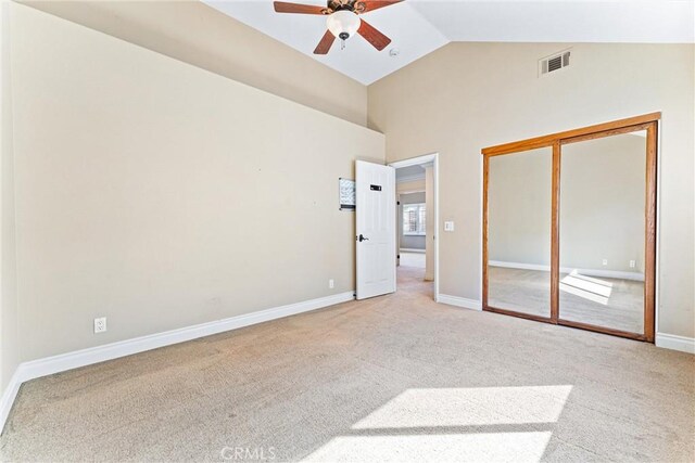 unfurnished bedroom with ceiling fan, carpet flooring, a closet, and vaulted ceiling