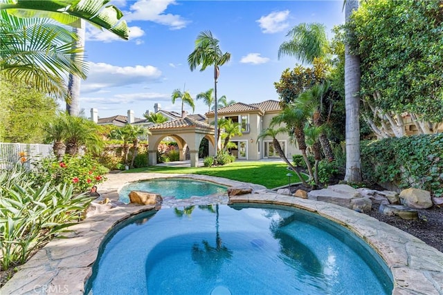 view of swimming pool with an in ground hot tub