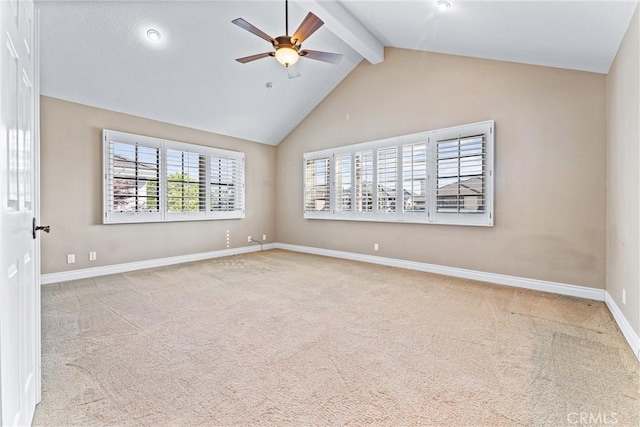 empty room with ceiling fan, light colored carpet, and lofted ceiling with beams