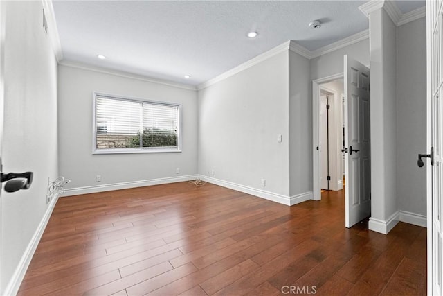 unfurnished room featuring dark wood-type flooring and ornamental molding