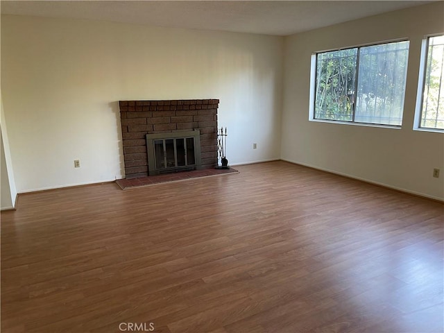 unfurnished living room with hardwood / wood-style floors and a fireplace