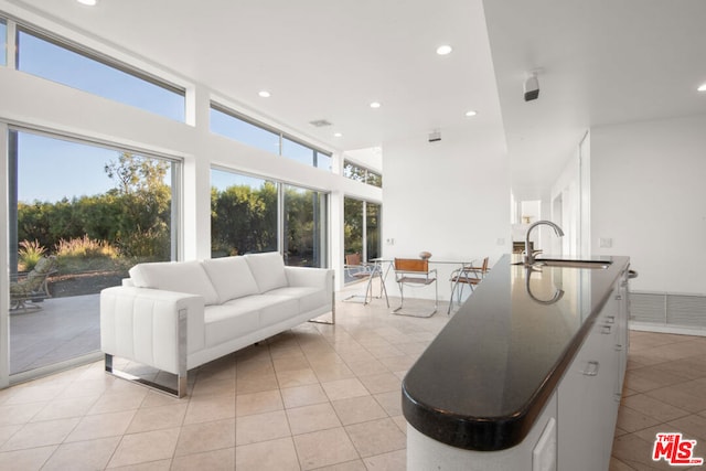 living room with sink and light tile patterned floors