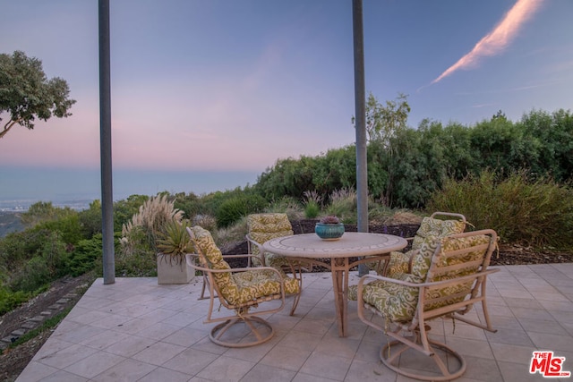 view of patio terrace at dusk