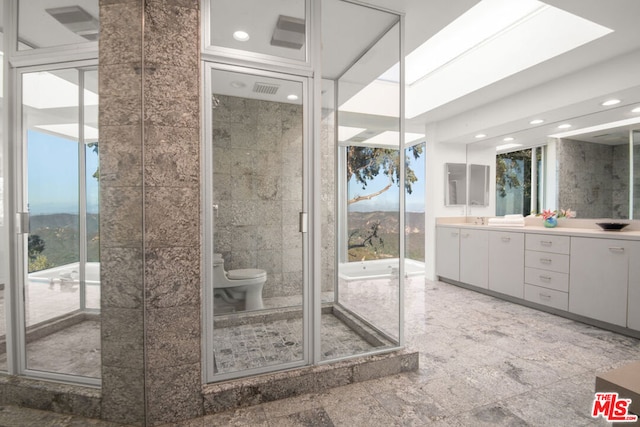 bathroom with toilet, a mountain view, vanity, and tile walls