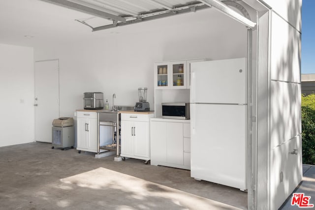 garage with white fridge