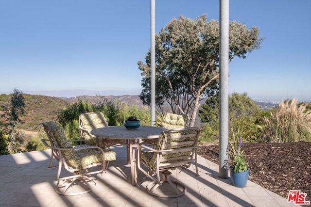 view of patio / terrace featuring a mountain view