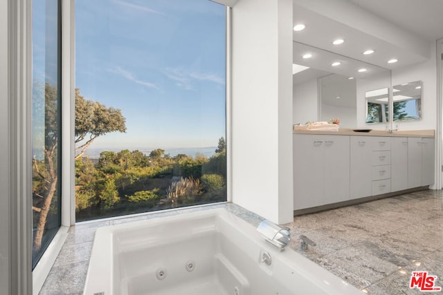 bathroom featuring sink and a washtub