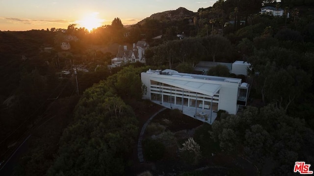 aerial view at dusk featuring a mountain view