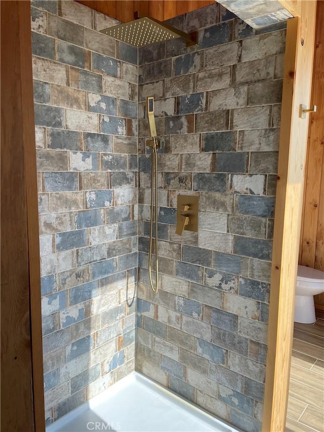 bathroom with hardwood / wood-style flooring and toilet