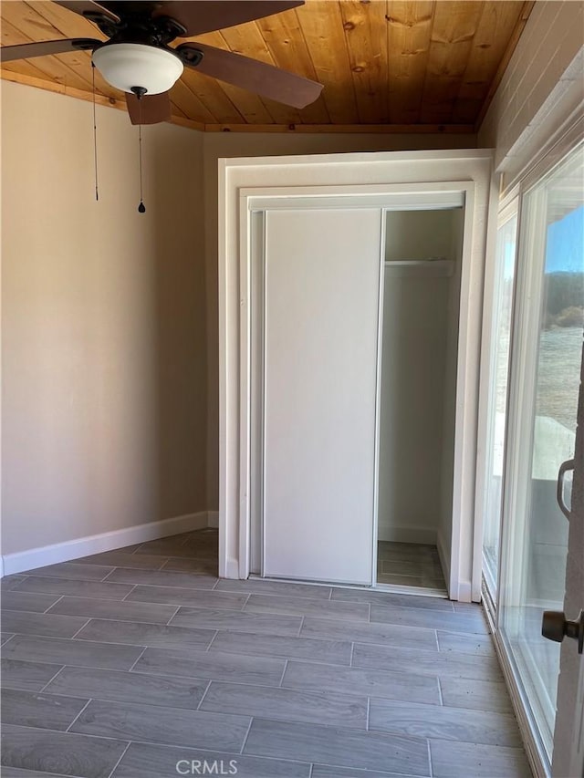 unfurnished bedroom with ceiling fan, light hardwood / wood-style floors, wood ceiling, and a closet