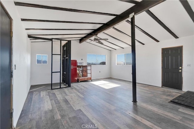 unfurnished living room featuring vaulted ceiling with beams, ceiling fan, and dark wood-type flooring