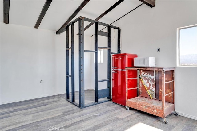 interior space with beamed ceiling and wood-type flooring