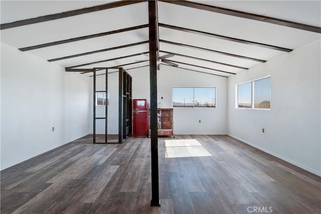 unfurnished living room featuring vaulted ceiling with beams and dark hardwood / wood-style floors