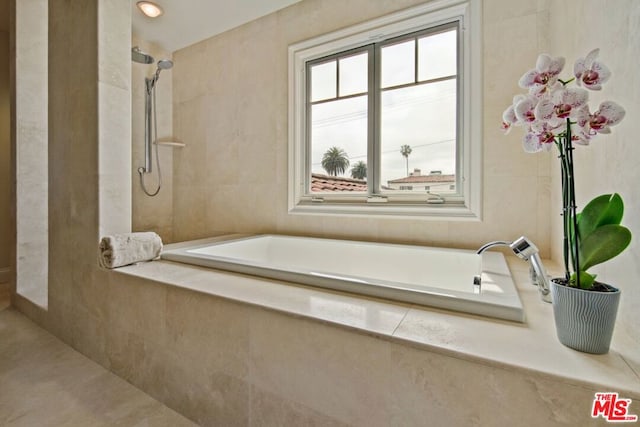 bathroom featuring separate shower and tub