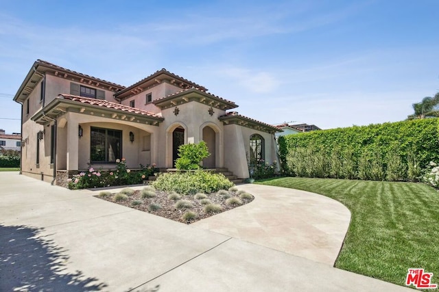 mediterranean / spanish-style home featuring a front lawn