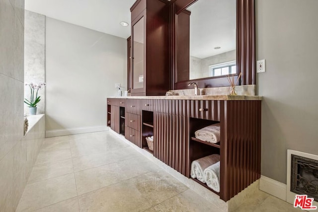 bathroom featuring vanity, tile patterned floors, and a bathing tub