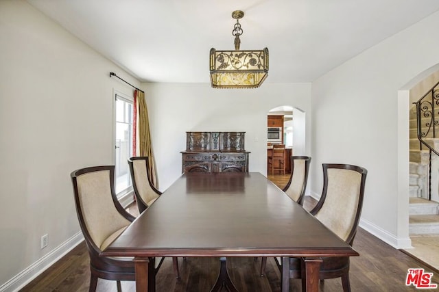 dining space with dark hardwood / wood-style floors