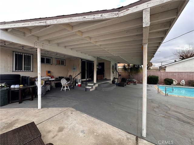 view of patio / terrace with a fenced in pool and fence