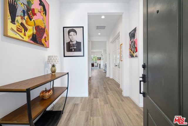 hall with light hardwood / wood-style floors