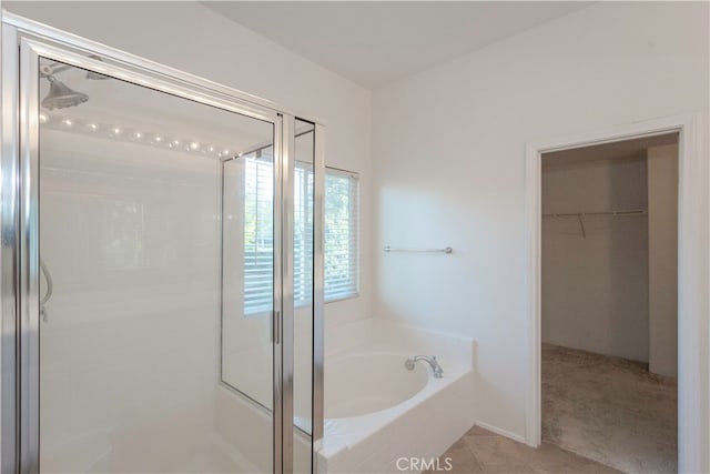 bathroom featuring independent shower and bath and tile patterned floors