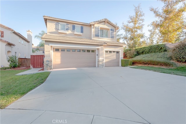 view of front of property featuring a front lawn and a garage