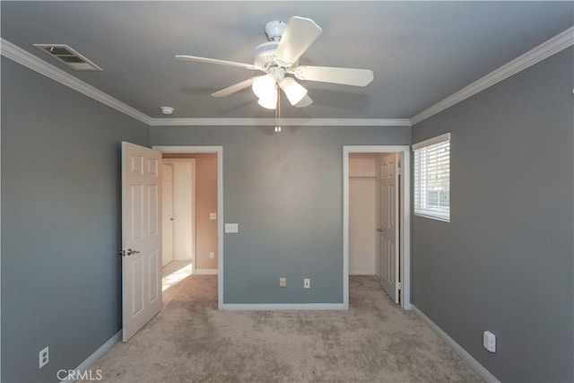 unfurnished bedroom featuring ceiling fan, light carpet, and crown molding