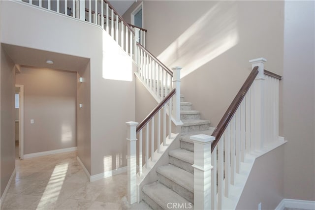 stairway with a towering ceiling