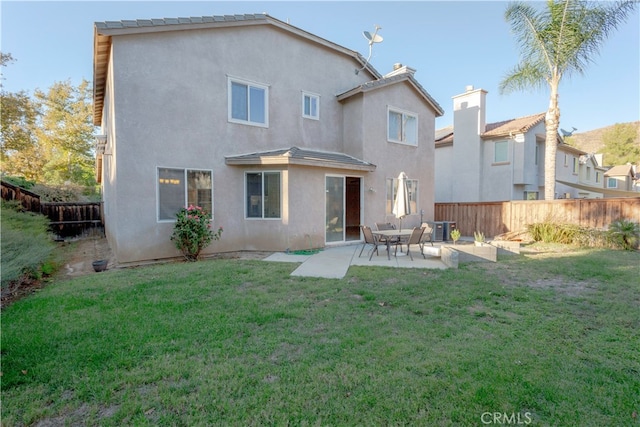 rear view of house featuring central AC unit, a patio area, and a lawn