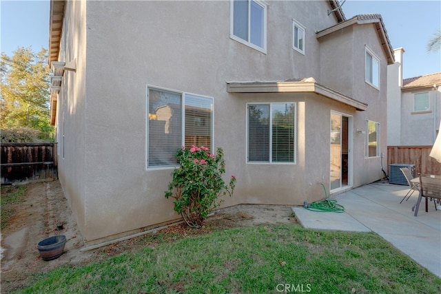 rear view of property with a patio area and central AC unit