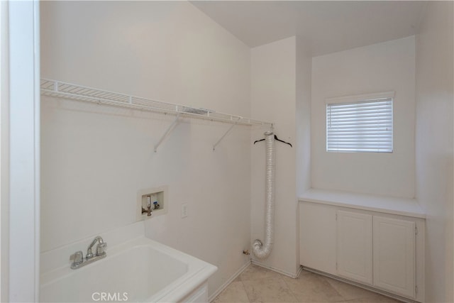 laundry room featuring sink, washer hookup, and light tile patterned floors