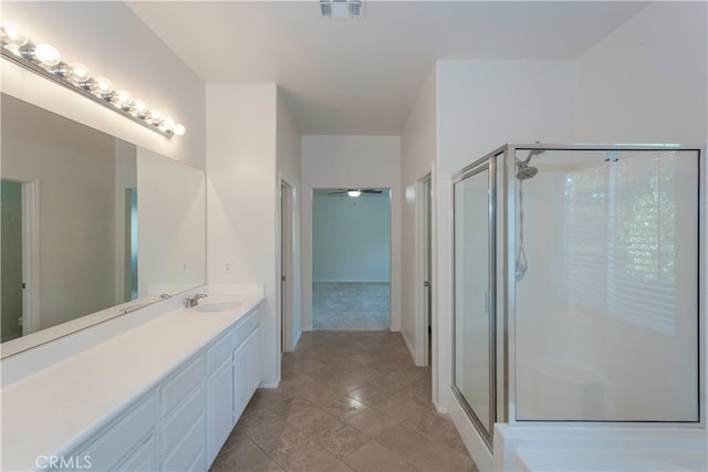 bathroom with vanity, tile patterned floors, and a shower with door