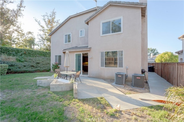 back of house featuring a patio, a lawn, and central air condition unit