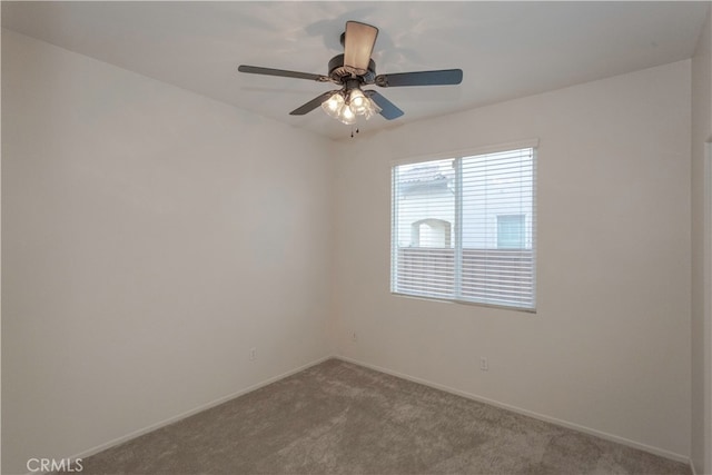 empty room featuring carpet flooring and ceiling fan