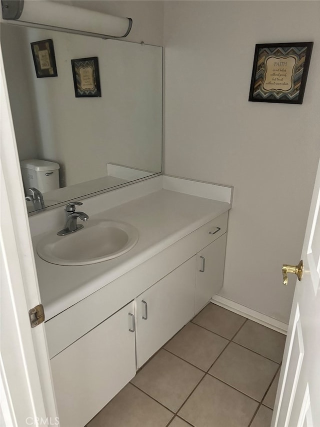 bathroom with vanity, toilet, and tile patterned flooring